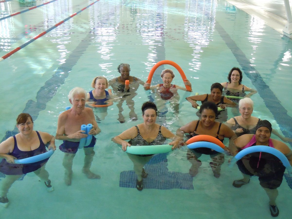 A group taking part in a water aerobics class in a swimming pool.