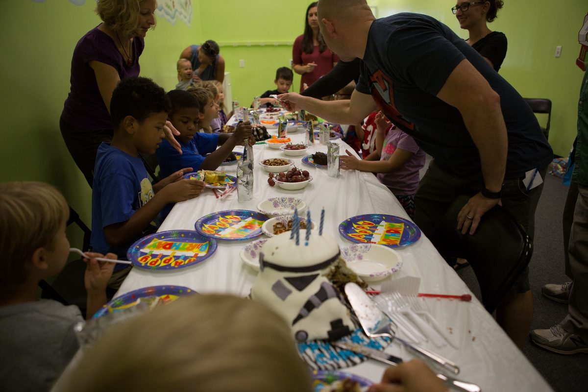Children and families gathered together at a pool party.